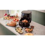 Air fryer with opned lid that shows capacity of it