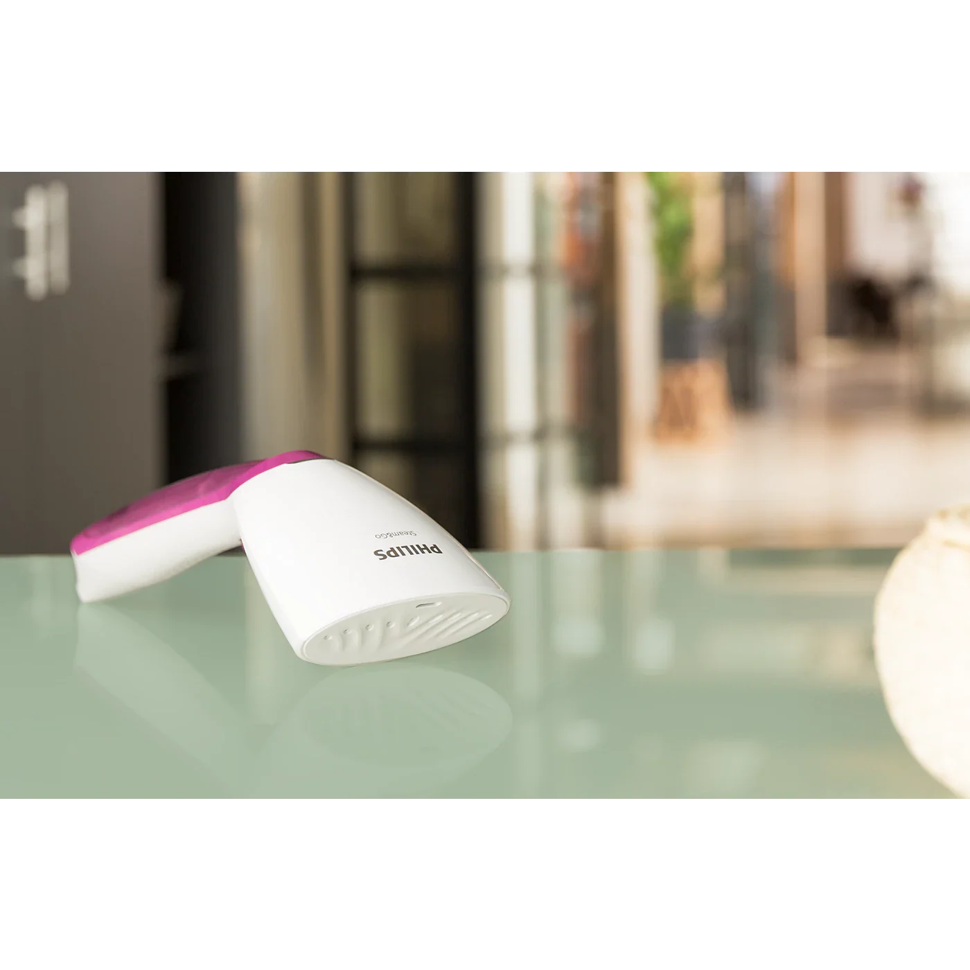 Image that girl is readying her baggage with hand steamer and it shows its portablility 