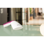 Image that girl is readying her baggage with hand steamer and it shows its portablility 