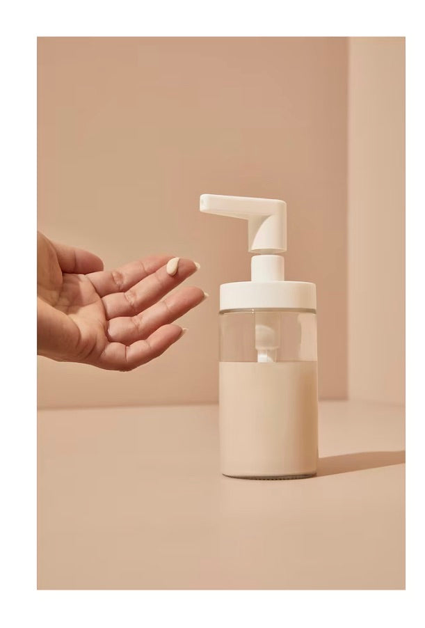 soap dispensor filled half of soap and shows how soap comming out from dispensor